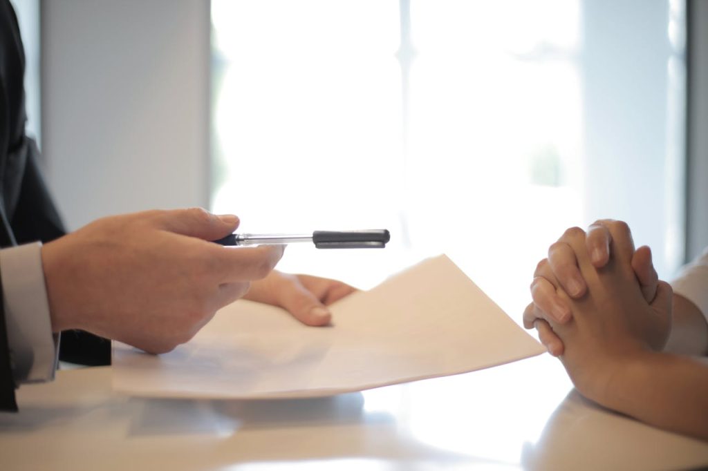 pexels-photo-3760067 Crop businessman giving contract to woman to sign